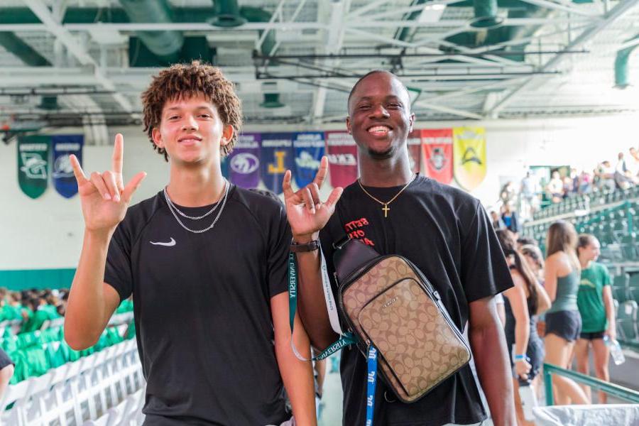 Jacksonville University students doing the Phin's Up! hand sign.